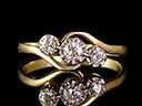 A beautiful Edwardian 18ct yellow Gold Diamond trilogy crossover ring, comprising of a beautiful central .08ct Old European Cut Diamond